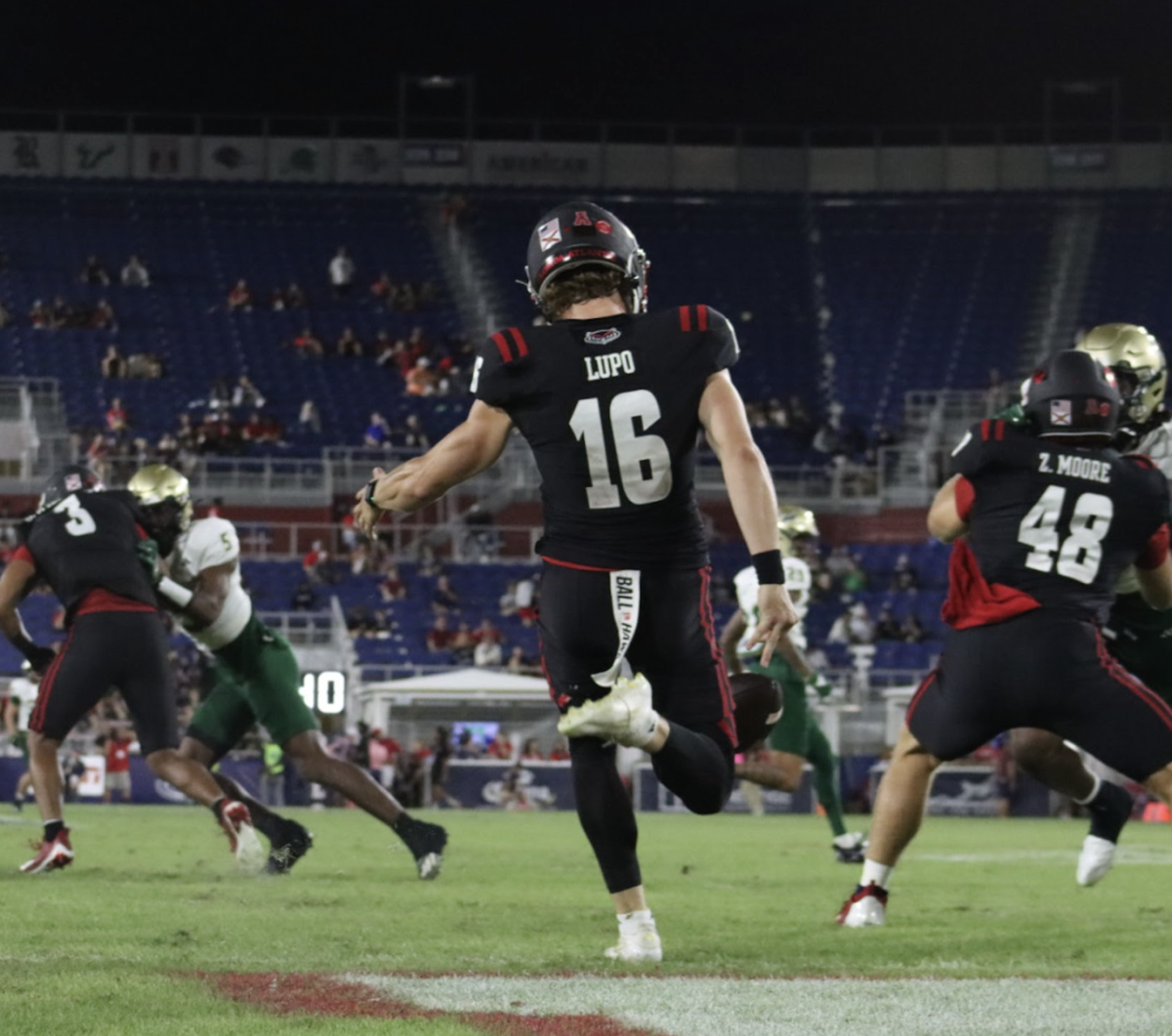 FAU kicker Logan Lupo punting in the Owls' homecoming game against USF on Nov. 1. 